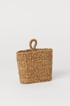 a woven basket with handle on the side