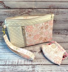 two purses sitting next to each other on a wooden surface