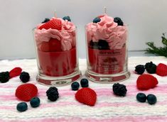 two jars filled with red, white and blue desserts on top of a table