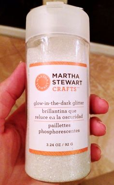 a hand holding a bottle of bath salts in it's left hand and the label says martha stewart crafts