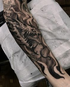 a man with a dragon tattoo on his arm