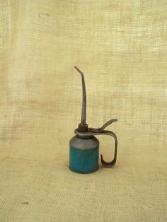 an old fashioned tea kettle sitting on top of a table