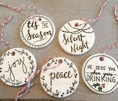 four ceramic ornaments that say it's the season silent night