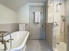 a white bath tub sitting next to a walk in shower