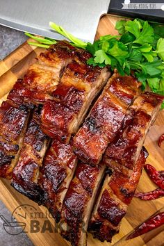 sliced up meat sitting on top of a wooden cutting board