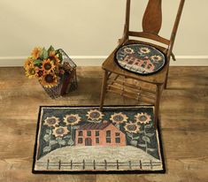 a wooden chair sitting on top of a hard wood floor next to a vase with sunflowers