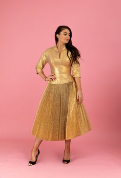 "A gorgeous 1950's Anita Bari of New York designer ensemble that will light up any room! This alluring matching set is made of an opulent metallic gold-lamé with a beautifully pleated skirt construction. This really gives the lamé depth and a bit of a soft sheen sparkle. The blouse has a chic collared plunge with 3/4-length sleeves. I love the hourglass nipped-waist design which flows into lined full swing-skirt. This is the type of look celebrity vixens, like Marilyn Monroe, made infamous. Extr Glamorous Gold Skirt For Evening, Glamorous Gold Evening Skirt, Retro Fitted Skirt For Party, Elegant Pleated Gold Skirt, Elegant Gold Pleated Skirt, Elegant Cocktail Skirt For Festive Occasions, Vintage Fitted Evening Skirt, Elegant Full Skirt In Gold, Festive Fitted Evening Skirt