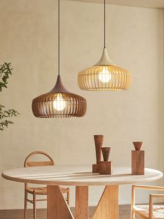 a dining room table with two hanging lights above it