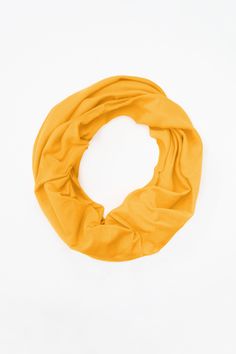 The Circle Scarf. That's Los Angeles. This multipurpose infinity scarf is made using cozy ribbed fabrics and can be styled in endless ways. Wear it as a hood, a shawl, basic scarf, double scarf, a dress, and more. Perfect to keep warm during the winter. | Circle Scarf in Gold Solid One Size Scarves For Fall, Solid Color Scarves One Size For Fall, Casual One Size Loop Scarves, Casual One-size Loop Scarf, Elegant Gold Scarf One Size, Casual One Size Loop Infinity Scarf, Casual One-size Loop Scarves, Solid Color Scarves For Fall, One Size, Casual Yellow Scarf One Size