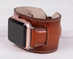 Experience the luxurious comfort and unparalleled craftsmanship of our burnished tan leather cuff Apple Watch band. This unique accessory blends classic design with modern functionality, making a bold statement on your wrist, designed to enhance your daily wear while showcasing your personal style. Completely Handmade Genuine Full-Grain Leather Special Cuff Style Design Durable, Stylish & Timeless Design Stainless-Steel Buckles - Secure & Strong Compatible with all Apple Watch Series (including Apple Watch Cuff, Brown Apple, Bracelet Apple Watch, Cuff Watch, Apple Watch Series 1, Leather Cuffs, Apple Watch Series, Accessories Unique, Gold Yellow