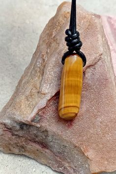 Tigers Eye stone necklace with adjustable cord. Perfect idea for gift. 1)-Stone size -18.5x17.5mm leather cord -2mm 1)-Necklace length 14"-28"(adjustable) --------------------------------------- 2)-Stone size -10.5x33mm (long shape) leather cord -2mm  (2)- necklace length 15"-30" adjustable (approx.) *Tiger Eye The zodiac stone for June, tiger's eye is in the quartz family. .it is, in fact, a good luck bringing stone that protects the wearing from evil thoughts and all ill wishes of enemies.it also possesses many healing properties. .Tiger Eye reduces the chronic pains, improves the strength of spines, and detoxifies the body. .It boosts up your confidence level. .It gets you mental clarity and decidedness. Pendant Necklace With Adjustable Waxed Cord, Brown Necklace With Sliding Knot For Gift, Brown Waxed Cord Necklace For Gift, Waxed Cord Pendant Necklace Gift, Adjustable Rectangular Necklace As A Gift, Minimalist Waxed Cord Jewelry As Gift, Adjustable Length Waxed Cord Jewelry For Gifts, Adjustable Rectangular Necklace For Gifts, Adjustable Rectangular Necklace For Gift