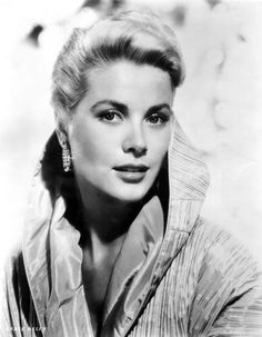 a black and white photo of a woman with blonde hair wearing large earrings, looking off to the side