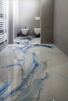 a bathroom with blue and white paint on the floor