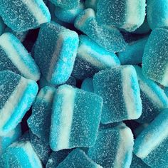 blue and white candies with sugar on them are piled up in a pile to be eaten