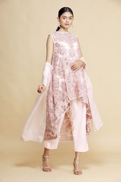 Pink asymmetric kurta with floral embroidered motifs. Paired with pant, dupatta and camisole.
Component: 4
Embroidered
Neckine: Round
Sleeve Length: Sleeveless
Fabric: Net
Color: Pink
Asymmetric kurta - Aza Fashions Asymmetric Kurta, Women Kurta, Kurta Set For Women, Embroidered Motifs, Kurta Set, Set For Women, Aza Fashion, Fashion Set, High Low Dress