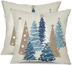 two pillows with christmas trees on them, one is blue and the other is white