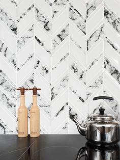 two salt and pepper shakers sitting on top of a counter next to a stove