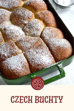 a green pan filled with powdered sugar covered bread