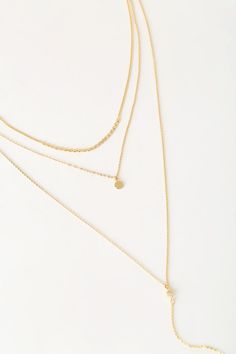 Lulus Exclusive! The Lulus Coretta Layered Gold Necklace is here to make your outfit perfect! Three layers of dainty gold chains, embellished with a row of round charms, a circle charm, and a drop chain embellished with a single rhinestone and bar charm, all come together to create a simple yet sweet look. Lobster clasp closure. Shortest necklace measures 13" long, with 4" drop chain, and a 2. 25" extender chain. Man made materials. Imported. Lulus | Coretta Layered Gold Necklace. Dainty Gold Layered Charm Necklaces, Dainty Layered Dangle Necklace For Layering, Charm Necklace With Delicate Chain And Round Pendant, Gold Dangle Layered Necklace With Delicate Chain, Gold Layered Dangle Necklace With Delicate Chain, Delicate Gold Layered Chain Necklace, Gold Minimalist Layered Dangle Necklace, Minimalist Gold Layered Dangle Necklace, Layered Necklaces Outfit