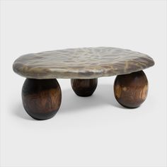 a wooden table with two brown vases sitting on it's legs and the top is