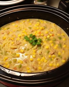 a crock pot filled with chicken noodle soup