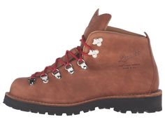 a pair of brown boots with red laces and flowers on the outstep