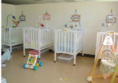 there are many cribs in this nursery room