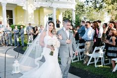 a bride and groom walking down the aisle