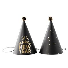 two black and gold party hats with happy new year written on the top one has a star design