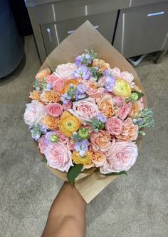 a person holding a bouquet of flowers in their hand