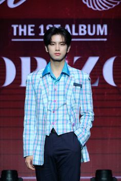 a male model in a blue and white checkered suit on the catwalk at tokyo fashion week