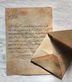 an old letter and origami are laying on a piece of paper