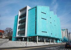 a large blue building sitting on the side of a road