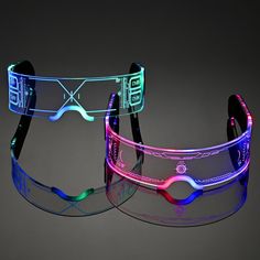 two glasses with different colored lights on the side and one has a cell phone attached to it