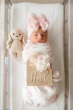 a baby sleeping in a crib next to a teddy bear and a sign that says hope