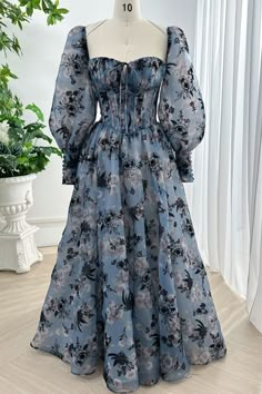 Indulge in luxury with our Corset Steal Blue Floral Print Organza Dress. The exquisite floral print and removable puff sleeves add a touch of glamour to this sophisticated piece. Made with high-quality organza, this dress will give you a flattering silhouette while making a statement at any event. Bust and Skirt with full lining. 100% Polyester 100% Recycled polyester lining Concealed zip at centre back Imported Floral Floor, Floral Dress Outfits, Floral Gown, Organza Dress, Blue Floral Print, Modest Fashion Outfits, Designer Gowns, Tea Length, Steel Blue