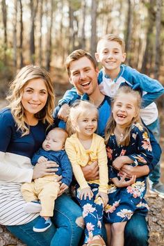 a family posing for a photo in the woods