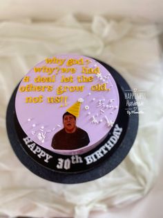 a birthday cake with an image of a man wearing a party hat on the top