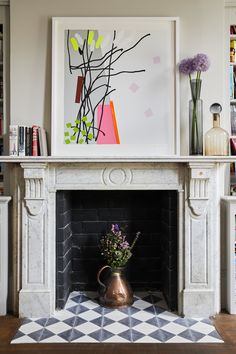 a fireplace in a living room filled with books and vases on top of it