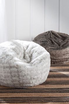 two bean bags sitting on top of a rug