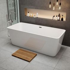 a white bath tub sitting on top of a tiled floor