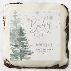 a cake with frosting on top of it that has a baby in the woods design