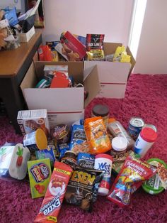 a pile of food sitting on top of a pink carpet next to a desk and chair