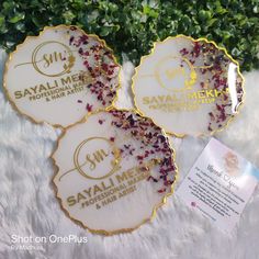 three white and gold coasters sitting on top of a furnishing covered floor