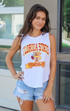 Love a cute tank top for game day?! This "Florida State" Vintage Curve Hem Tank is the cutest style - great for moms and daughters alike! Whether you keep it casual with cute jean shorts or dress it up with your favorite skirt - this sleeveless tank is the perfect choice for those Tallahassee game days at Doak. Details: *OFFICALLY LICENSED* Vintage Washed Cotton Tank 100% Cotton Crew Neckline, Sleeveless, Full Length with curved hemline, Bra Friendly Features a Vintage FSU Logo with Garnet & Gol Fsu Logo, Moms And Daughters, Cute Jean Shorts, Tallahassee Florida, Fashion Bottoms, Florida State University, Florida State Seminoles, Cute Tank Tops, Cute Jeans