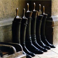 the boots are lined up against the wall