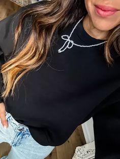 Elevate a scuba sweatshirt with a bow necklace for a simple stylish look. Small sweatshirt. Click on my link below to shop. Affiliate Link: https://liketk.it/4VV1U #LTKHoliday#LTKFindsUnder100#LTKFindsUnder50 Scuba Sweatshirt, Bow Necklace, A Black