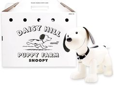 a toy dog next to a white box with the words daisy hill puppy farm shoppy on it