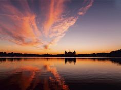 the sky is reflected in the water at sunset