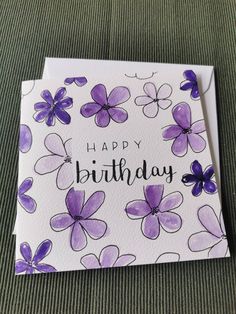 a birthday card with purple flowers on it